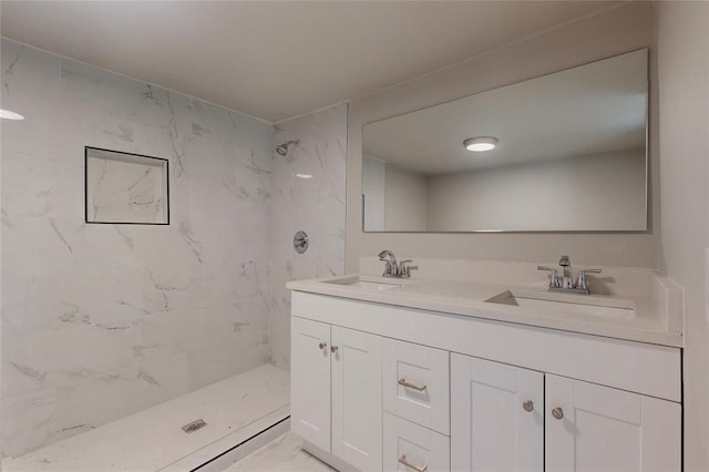 bathroom featuring vanity and tiled shower