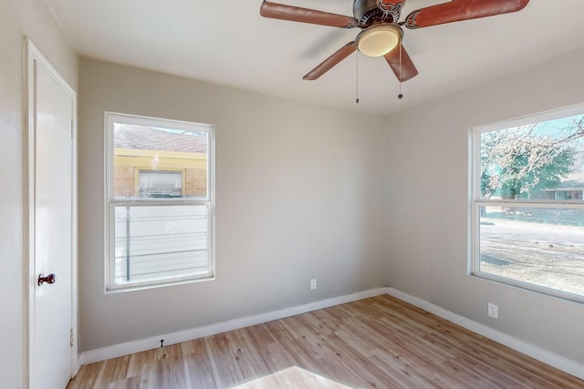 empty room with ceiling fan and light hardwood / wood-style floors