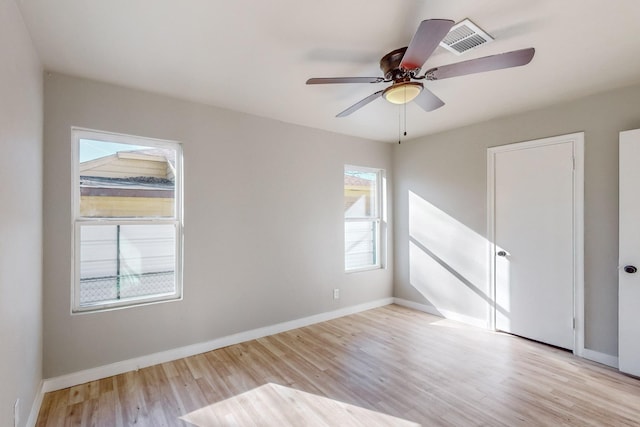 unfurnished room featuring ceiling fan, a healthy amount of sunlight, and light hardwood / wood-style flooring