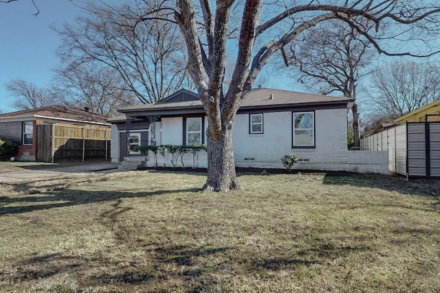 back of property featuring a yard and a shed