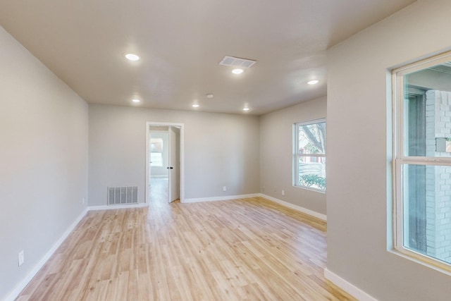 empty room with light hardwood / wood-style flooring