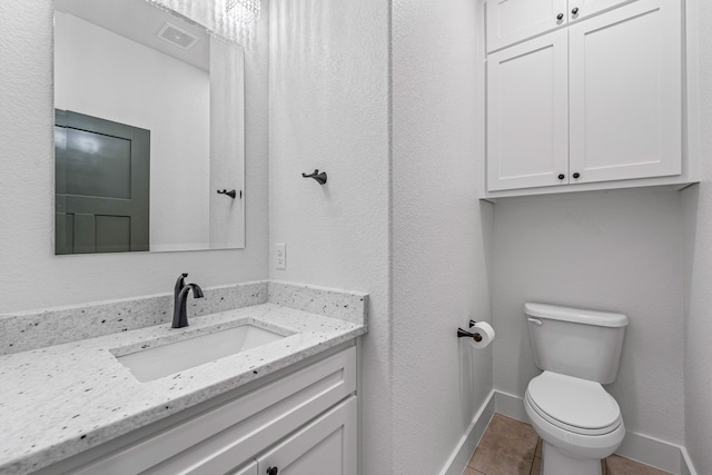 bathroom featuring tile patterned floors, toilet, and vanity