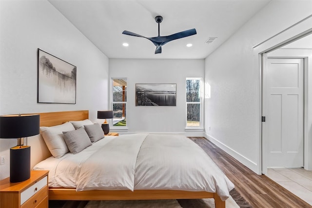 bedroom with ceiling fan and wood-type flooring