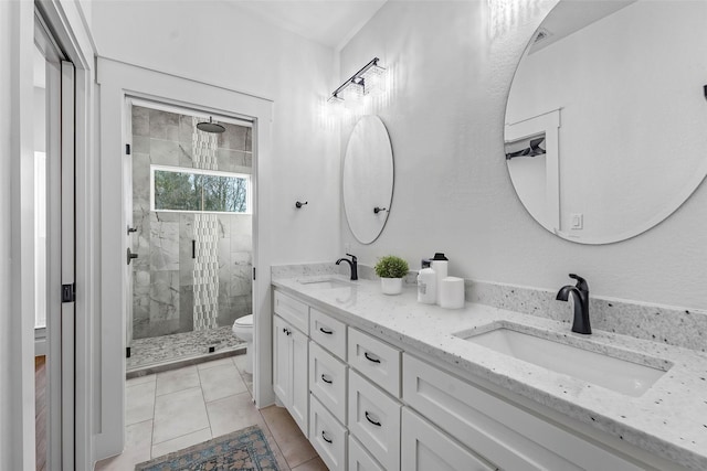 bathroom featuring tile patterned floors, vanity, toilet, and an enclosed shower