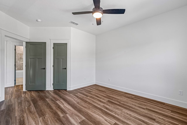 unfurnished bedroom featuring dark wood-type flooring and ceiling fan