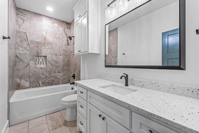 full bathroom featuring vanity, tiled shower / bath combo, tile patterned floors, and toilet