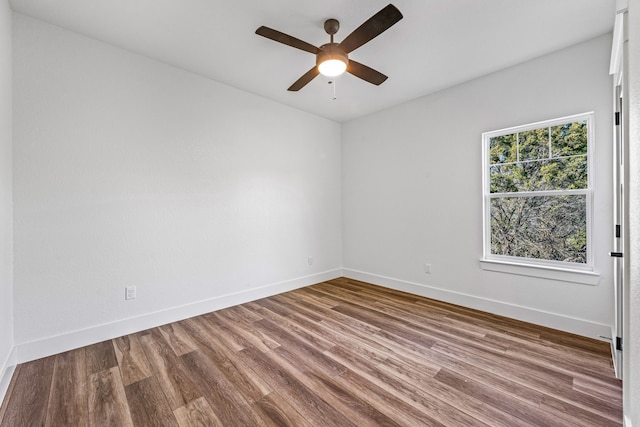 unfurnished room with hardwood / wood-style flooring and ceiling fan