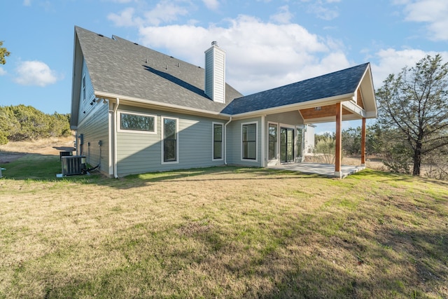 back of property featuring a yard, central AC unit, and a patio area