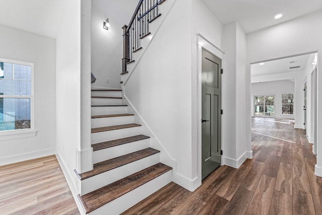 stairs featuring hardwood / wood-style flooring