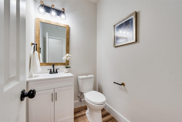 bathroom with vanity, hardwood / wood-style floors, and toilet