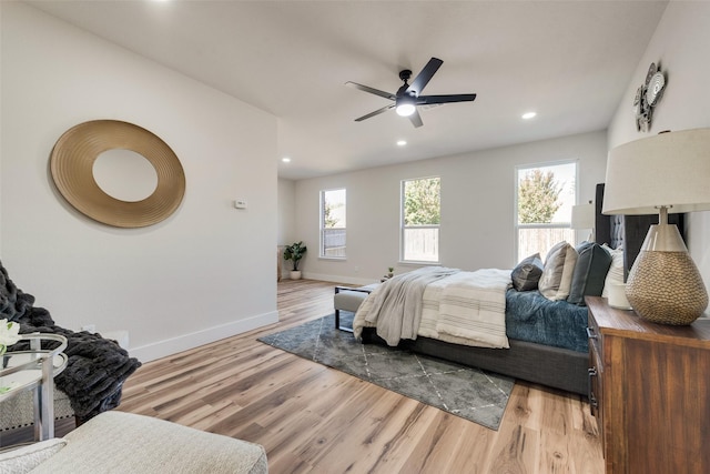 bedroom featuring multiple windows, ceiling fan, and light hardwood / wood-style floors