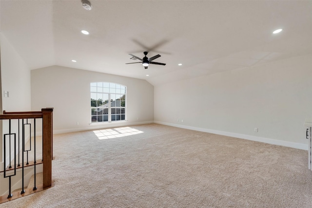 spare room featuring lofted ceiling, light colored carpet, and ceiling fan