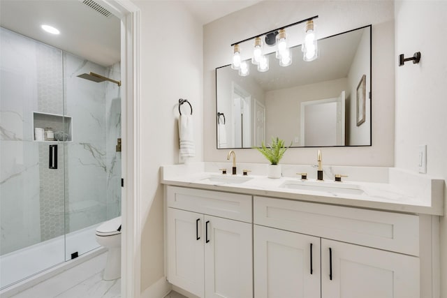 bathroom featuring walk in shower, vanity, and toilet