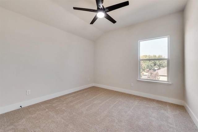 empty room with lofted ceiling, carpet floors, and ceiling fan