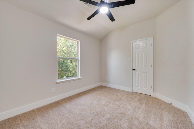 carpeted empty room featuring ceiling fan and vaulted ceiling