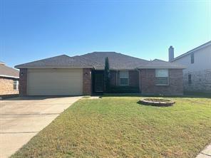 single story home with a front yard and a garage