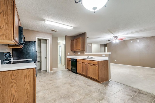 kitchen featuring black appliances, sink, ceiling fan, kitchen peninsula, and a textured ceiling