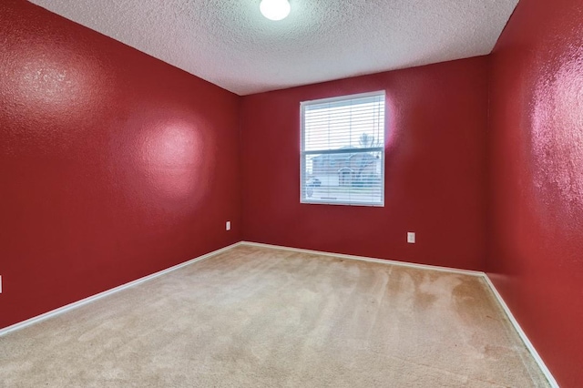 unfurnished room with a textured ceiling and carpet