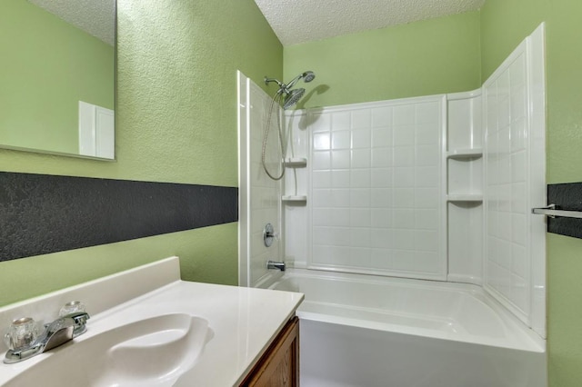 bathroom featuring vanity, bathtub / shower combination, and a textured ceiling