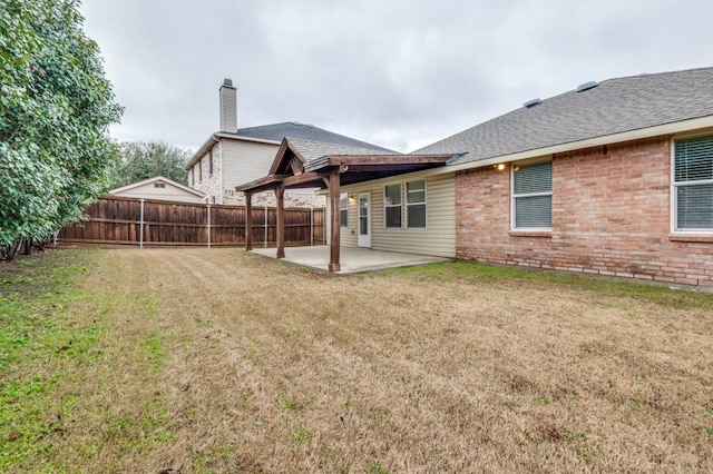 rear view of house featuring a yard and a patio