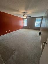 unfurnished room with ceiling fan and carpet floors