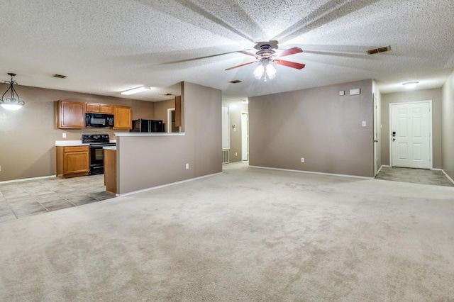 unfurnished living room with light carpet, ceiling fan, and a textured ceiling