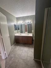 bathroom featuring vanity and an enclosed shower