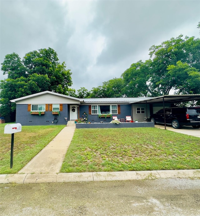 ranch-style house featuring a carport and a front lawn