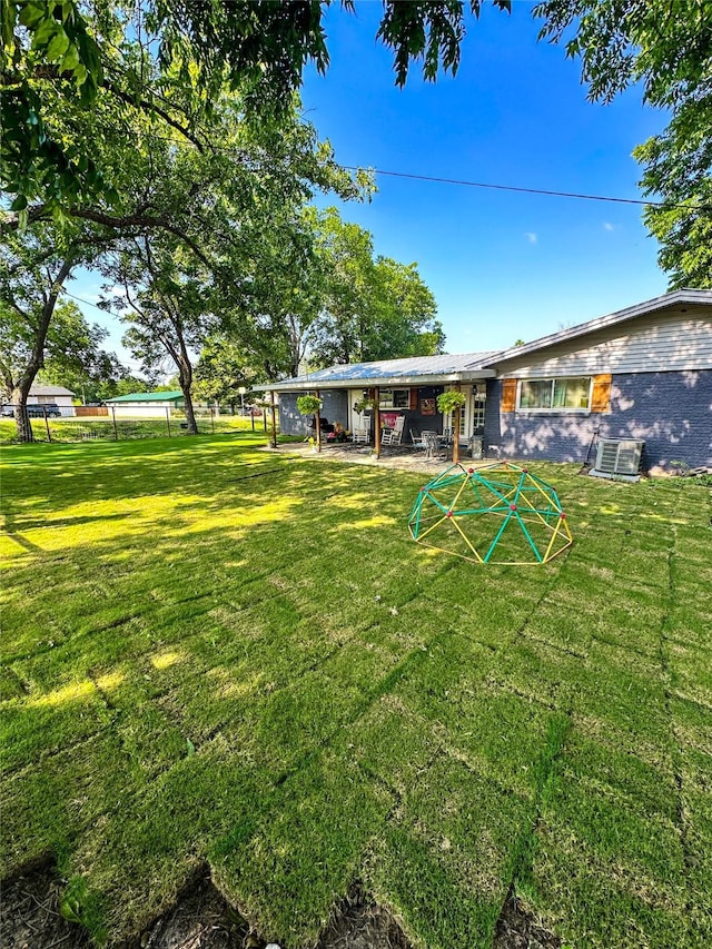 view of yard featuring cooling unit and a patio