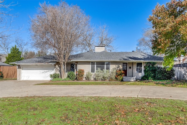 ranch-style home featuring a garage and a front lawn