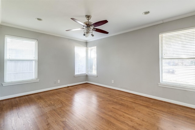 empty room featuring wood-type flooring, ceiling fan, and crown molding