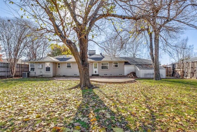 rear view of property with a lawn, a patio area, and central air condition unit