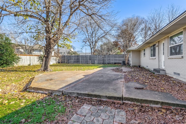 view of yard featuring a patio area and central air condition unit