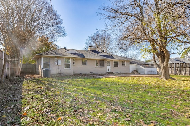 rear view of house with central AC unit, a yard, and a patio