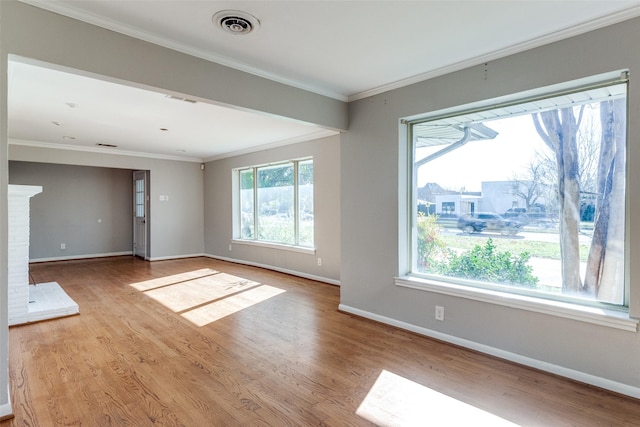 unfurnished living room with light hardwood / wood-style floors and ornamental molding