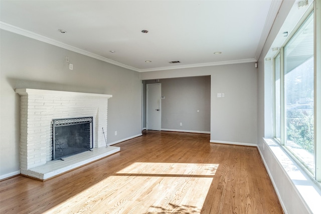 unfurnished living room with a fireplace, wood-type flooring, and ornamental molding