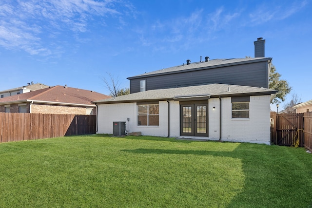 back of house with french doors, a yard, and central AC unit