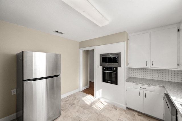 kitchen with light countertops, appliances with stainless steel finishes, visible vents, and white cabinets