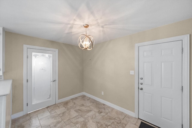 unfurnished dining area with baseboards and a notable chandelier