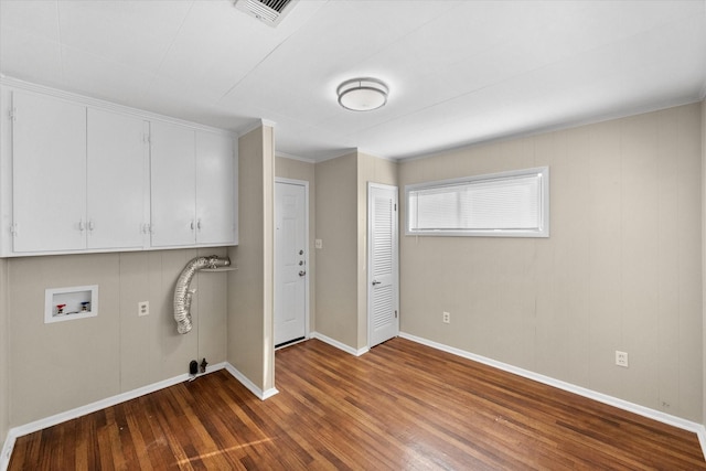 clothes washing area with visible vents, washer hookup, wood finished floors, and cabinet space