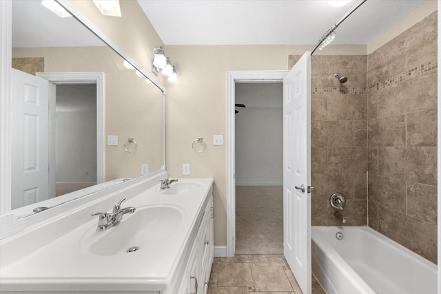 full bathroom featuring  shower combination, double vanity, a sink, and baseboards