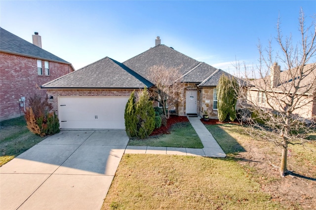 view of front of house featuring a front yard and a garage