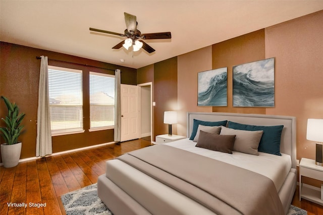 bedroom featuring ceiling fan and dark wood-type flooring