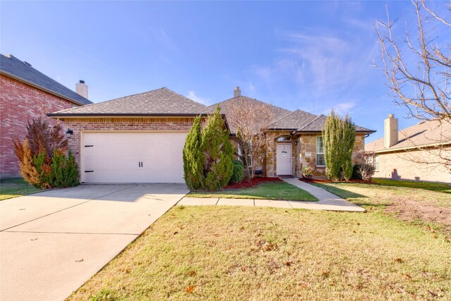 single story home featuring a front yard and a garage