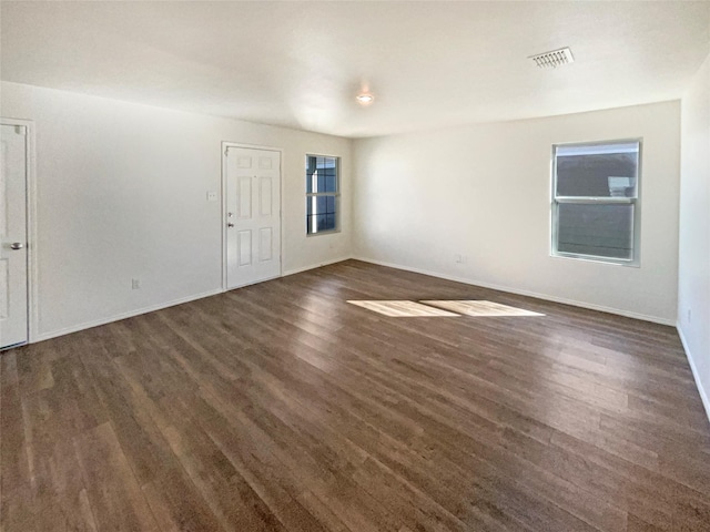 empty room featuring dark wood-type flooring