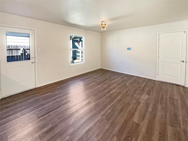 unfurnished room with dark hardwood / wood-style flooring