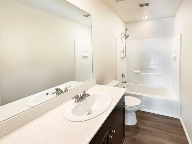 full bathroom featuring hardwood / wood-style floors, vanity, toilet, and tub / shower combination