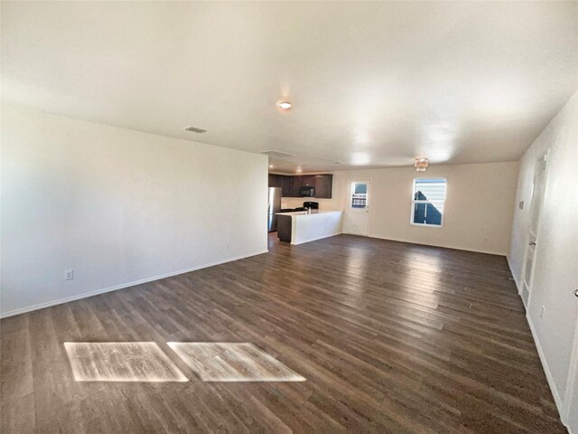 unfurnished living room featuring dark wood-type flooring