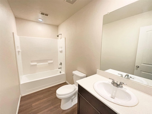 full bathroom with shower / tub combination, vanity, wood-type flooring, and toilet