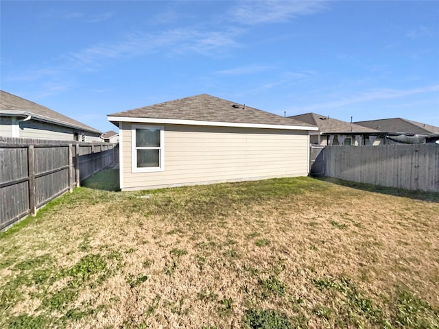 rear view of property featuring a yard